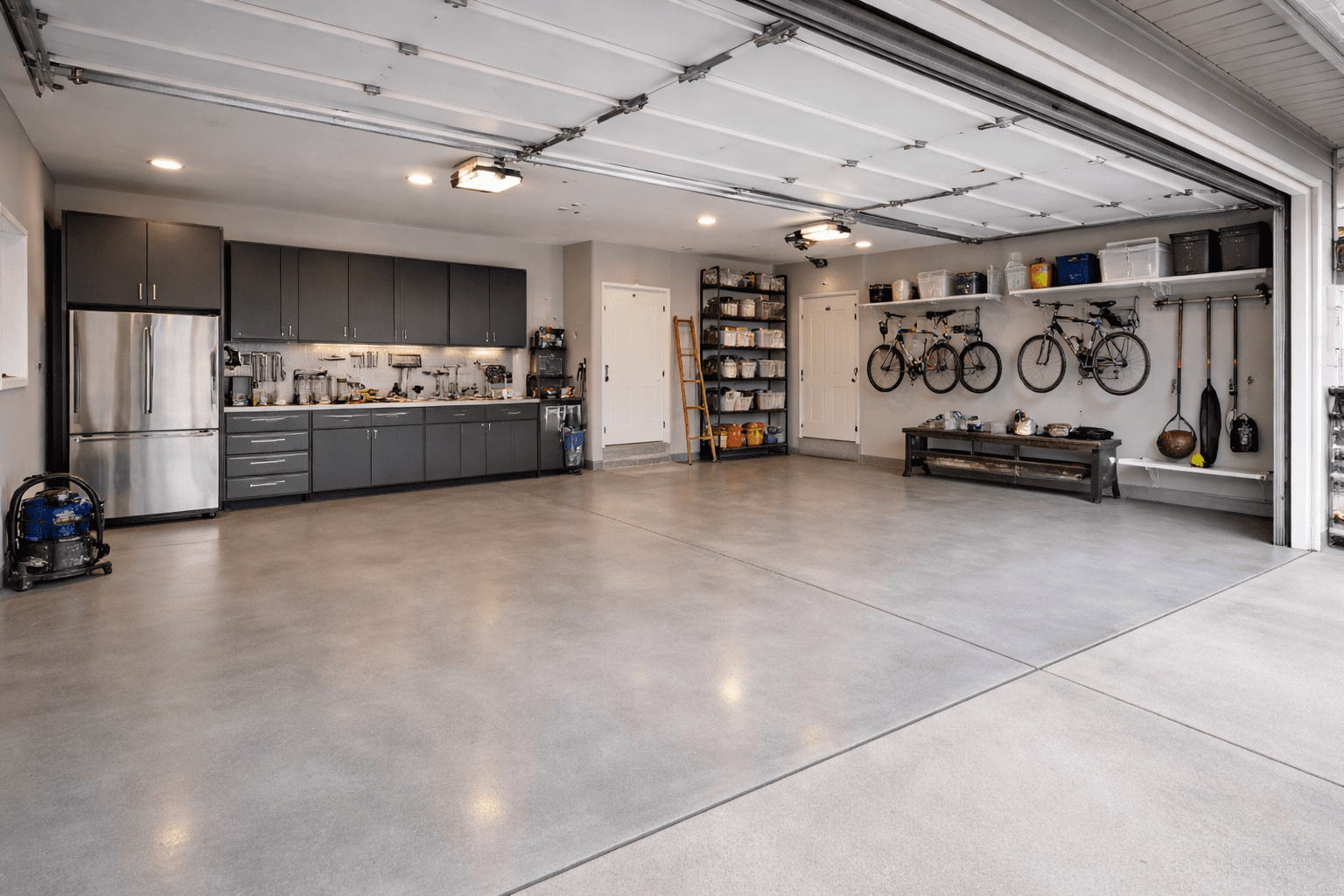 Concrete Garage Floor in Bay View WI done by Concrete Contractor Morici Bros Concrete LLC Concrete garage floor with organized storage, wall-mounted bicycles, and modern cabinetry, showcasing durability and functionality for Bay View properties.