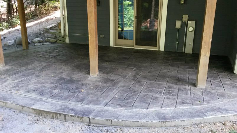 Stamped concrete patio installed by Morici Bros Concrete LLC, featuring a textured design and complementing the home's exterior.