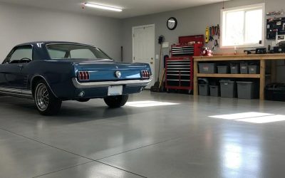 Durable concrete garage floor with a classic blue vehicle parked inside, showcasing functionality and aesthetics, ideal for homeowners in West Allis, WI.