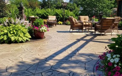 Stamped concrete patio in Milwaukee featuring intricate patterns, vibrant flowers, and outdoor seating area.