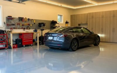Durable concrete garage floor showcasing a sleek black car in a well-organized residential garage with tools and storage units.