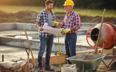 Homeowner consulting with a concrete contractor at a construction site, discussing plans for concrete projects like entryway steps and patios in South Milwaukee.