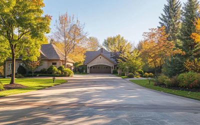 Residential driveway and walkway installation featuring a concrete surface, surrounded by landscaped trees and shrubs in Greenfield, WI, showcasing a safe and appealing pedestrian path.